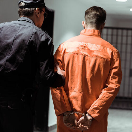 A Guard Leads a Prisoner to His Cell.