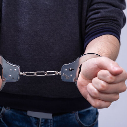 close-up of a man's hands in handcuffs