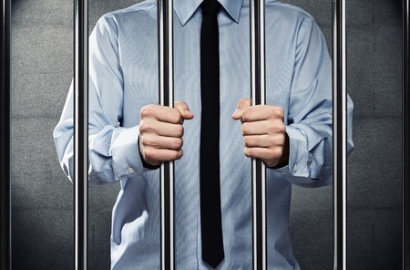 Photo of man behind bars