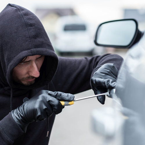 thief breaking into a car