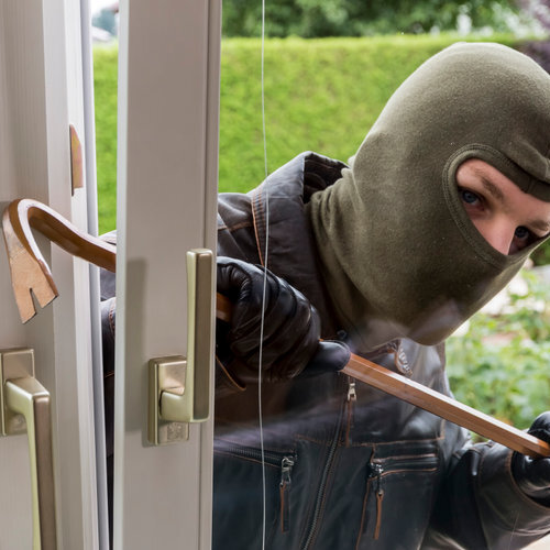burglar breaking into a glass door