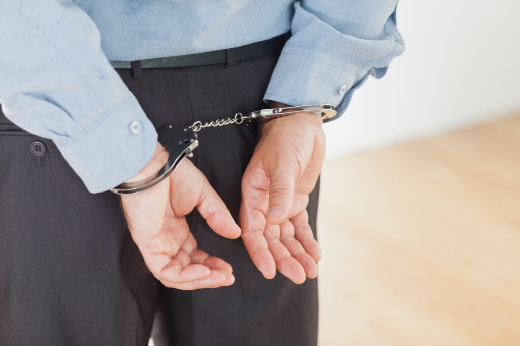 hands arrested by handcuffs